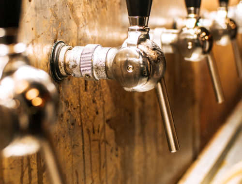 Many taps with a wooden background and black handle